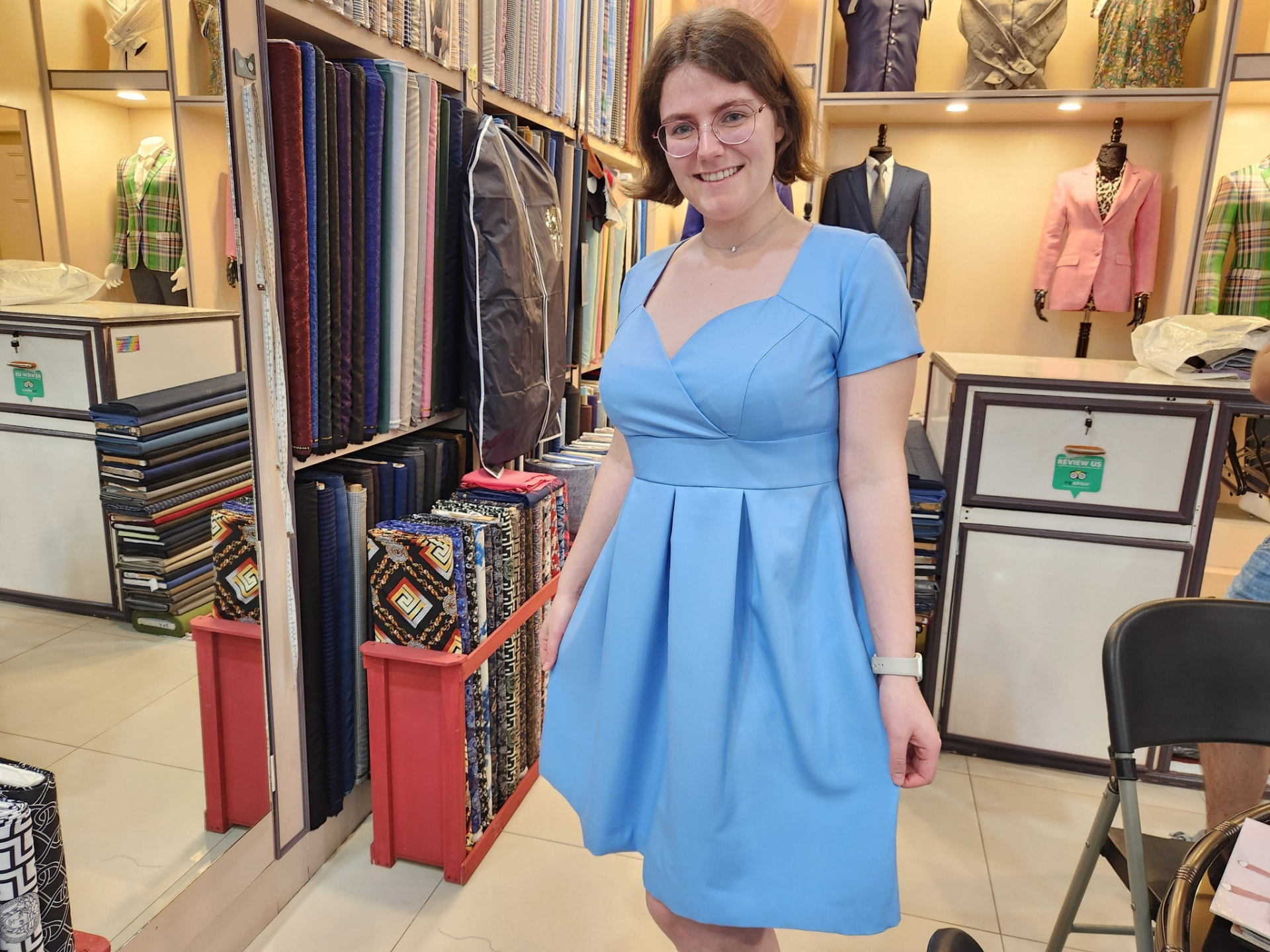 Customer wearing a custom light blue dress made by Sam Boutique Tailors Phuket