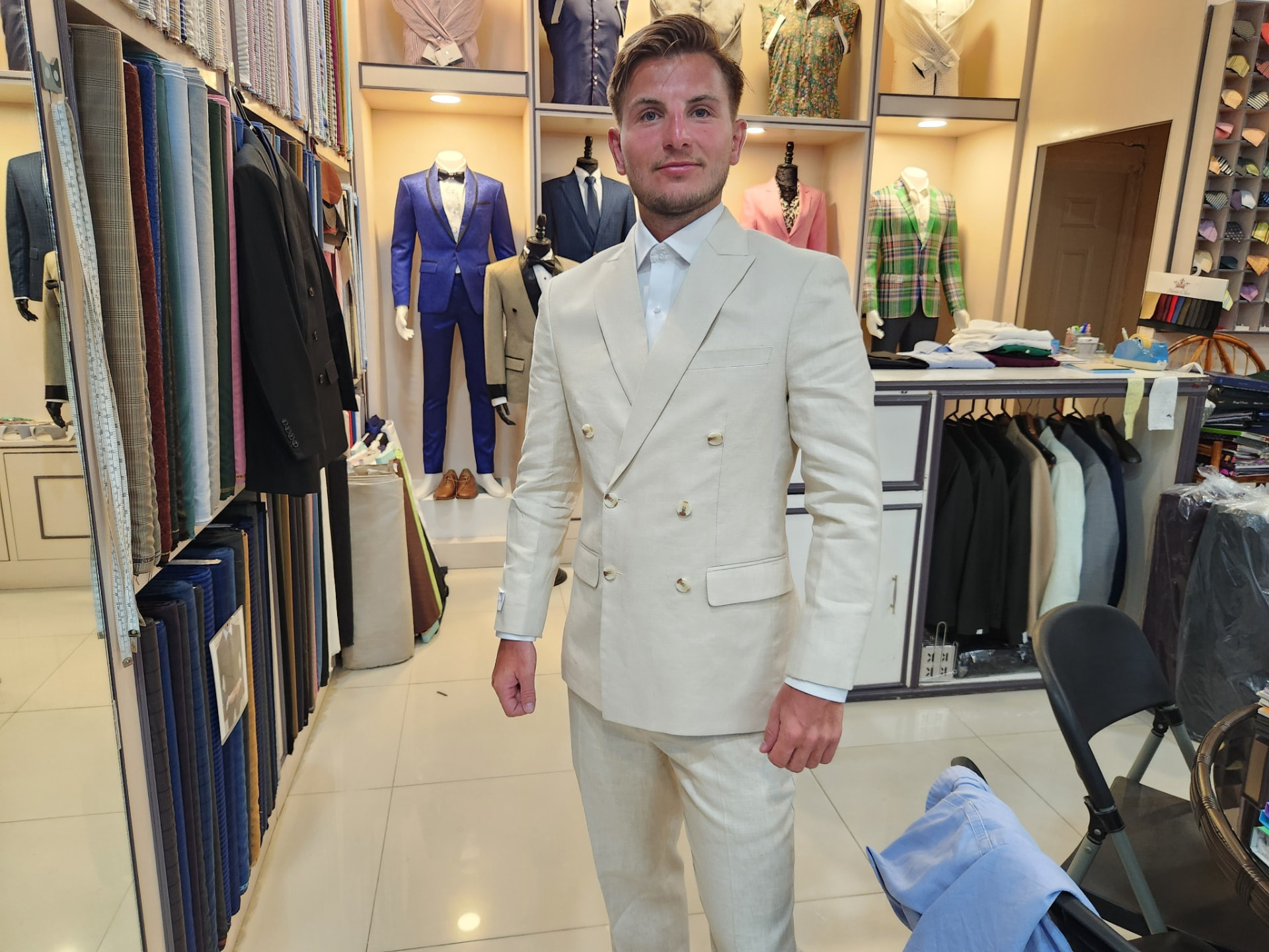 Customer wearing a cream double-breasted linen suit made by Sam Boutique Tailors Phuket