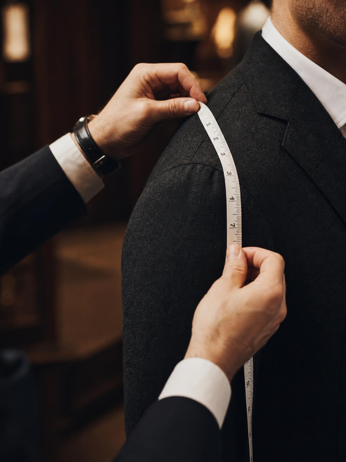 Tailor measuring a client's chest at Sam Boutique Tailors Phuket